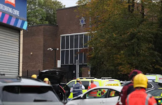 Manchester Synagogue knife Attack Leaves 2 Dead, 3 Seriously Injured on Yom Kippur. Two people have died and three others are in serious condition after a stabbing and car attack outside the Heaton Park Hebrew Congregation Synagogue in Manchester on Yom Kippur. Greater Manchester Police (GMP) said they were called shortly after 9:30 a.m. on Thursday, Oct. 2. A car had been driven into worshippers, and a man and a security guard were stabbed. Police confirmed two victims had died. The suspected attacker was shot by GMP firearms officers and is also believed to be dead, though confirmation is pending due to suspicious items on his body. A bomb disposal unit was deployed. Authorities said a large number of worshippers were inside the synagogue during the attack. GMP praised a bystander whose quick action prevented the attacker from entering the building. Prime Minister Keir Starmer called the incident “all the more horrific” given its timing on Yom Kippur. King Charles also expressed shock and praised the swift response of emergency services. Police said the attack has caused “significant shock and fear” across communities. Security has been increased at synagogues throughout Greater Manchester.
